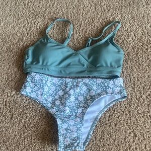 Green bathing suit with printed bottoms  Liner in the bottoms is still in there